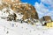 Wolkenstein in Groeden in winter with chairlift and skiers, Dolomite, Italy