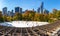 Wollman Skating Rink on a sunny morning in autumn, Central Park South and Midtown Manhattan skyscrapers. New York City