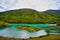 Wolong Bay of Kanas Lake. Crystal blue river, small sandbar.Green tree hills