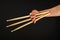 Wolverine hand with three drumsticks over black