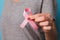 Womaen hand holding pink ribbon breast cancer awareness. concept healthcare and