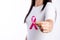 Womaen hand holding pink ribbon breast cancer awareness. concept healthcare and medicine