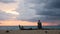 A womam is Sitting on a beach in Puerto Rico, watching the sunset and the arrival of a storm over the Caribbean Sea. Rincon,