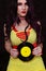 Woman in 1980s yellow clothing holding 45rpm record. Record label painted with yellow poster paint