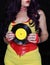 Woman in 1980s yellow clothing holding 45rpm record. Record label painted with yellow poster paint