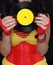 Woman in 1980s yellow clothing holding 45rpm record. Record label painted with yellow poster paint