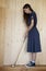 Woman in 50s clothes holding retro golf stick