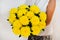 Woman with abouquet of yellow chrysanthemums. Beautiful fresh yellow flowers for holiday. Woman holding beautiful yellow flowers