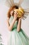 Woman with accessory on head posing with bananas on white