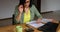 Woman accountant sit calculate expenses on calculator at wooden table, modern workplace