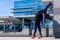 Woman acrobat is doing yoga action and building made of glass