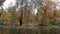 Woman acrobat hanging on the aerial silk and shows a show of air acrobatics in the forest.