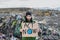 Woman activist with placard poster on landfill, environmental pollution concept.