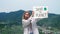 Woman activist portrait holding save the planet green poster.