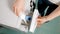 Woman adding detergent to compartment in washing machine and closing drawer