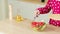 Woman adding fresh cherry tomatoes in glass bowl with salad. Vitamins, dietary and sports nutrition. Vegetarian food.