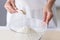 Woman adding powdered yeast to flour