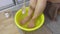 Woman adding sea salt in a bowl of water