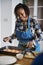 Woman adding spices and herb to raw salmon