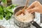 Woman adding spices to tasty rice in saucepan