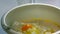 The woman adds chicken eggs to the dough. It breaks the shell about the edge of the basin, in which there is a mixture of cottage