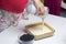 The woman adds the filling to the biscuit. Delicate cheesecake with blueberries. Ingredients: cookies and lemon stand on the tabl