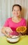 Woman adds raisin into dough