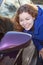 Woman admire oneself in car rear-view side mirror