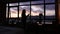 Woman admire sunset from window and drink water, Barcelona