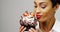 Woman admiring a fancy dessert cupcake with chocolate and strawberries