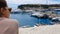 Woman admiring seascape with yachts, seagulls flying close, pleasant rest