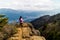 A woman admiring the spectacular view after a long hike