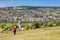 Woman admiring view across to Stroud from Selsley Common, The Cotswolds, Gloucestershire, England