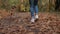 Woman with adorable dog jogging in autumn park