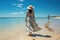 Woman adorned in white dress and sun hat at the seashore, summer season nature image