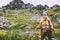 Woman adventurer hiking at rocky mountains