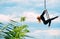 Woman aerialist performs acrobatic elements in hanging aerial hoop
