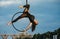 Woman aerialist performs acrobatic elements in hanging aerial hoop