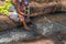 Woman in African outfit on the verge of fluent river. Interacting with water. Angola.