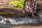 Woman in African outfit on the verge of fluent river. Interacting with water. Angola.