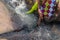 Woman in African outfit on the verge of fluent river. Interacting with water. Angola.