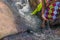 Woman in African outfit on the verge of fluent river. Interacting with water. Angola.