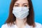 Woman against corona virus in mask. light blue background