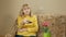 Woman aged switches remote control TV channels on the couch at home. She is resting after a hard day. holiday concept