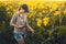 Woman agronomist checks blooming sunflower growth rates on an eco farm