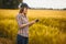 Woman agronomist checks cereal growth rates on an eco farm