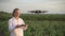 Woman agronomist controls drone.