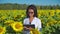 Woman agronomist doing quality control in sunflower field