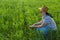 A woman agronomist in the field is engaged in quality control of crops.