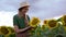 Woman agronomist standing agricultural sunflower field Caucasian female farmer straw hat Portrait agribusiness worker